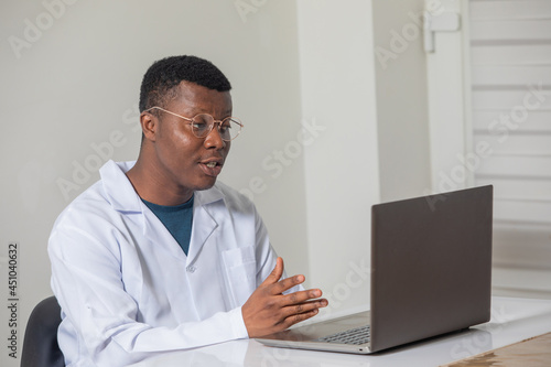 Young doctor gaining new knowledge using laptop