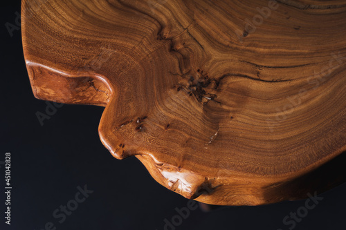 Slab, saw cut wood treated with varnish close-up on a black background. Isolate.