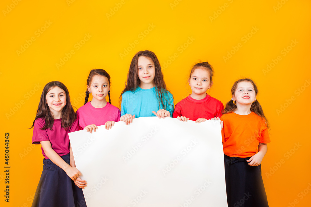 The different little boys are holding a big white paper The different little boys are holding a big white paper