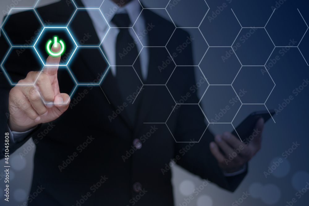 A businessman who taps the touch screen on the hexagon button on the internal digital interface shows a solid start icon. Technology and alternative concepts, business growth, business networking. A businessman who taps the touch screen on the hexagon button on the internal digital interface shows a solid start icon. Technology and alternative concepts, business growth, business networking.