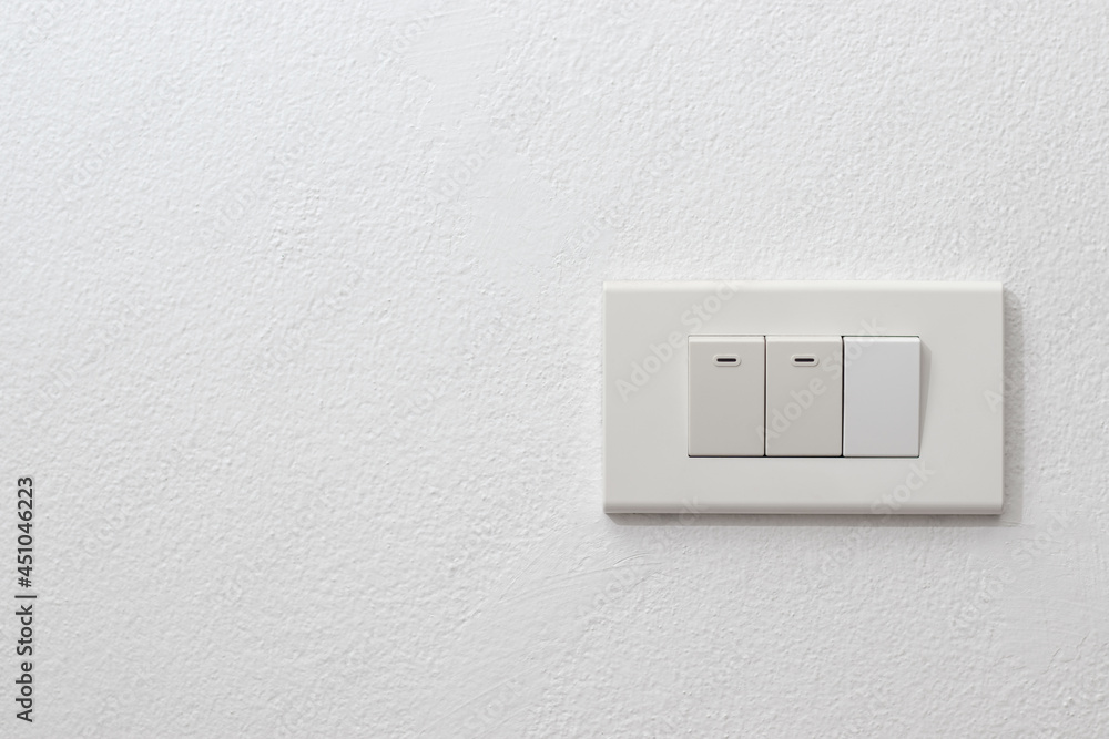 Light onoff switch on white wall with space for text. Light onoff switch on white wall with space for text.