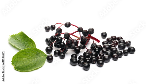 Elderberries, elder berries pile with green leaf, isolated on white background