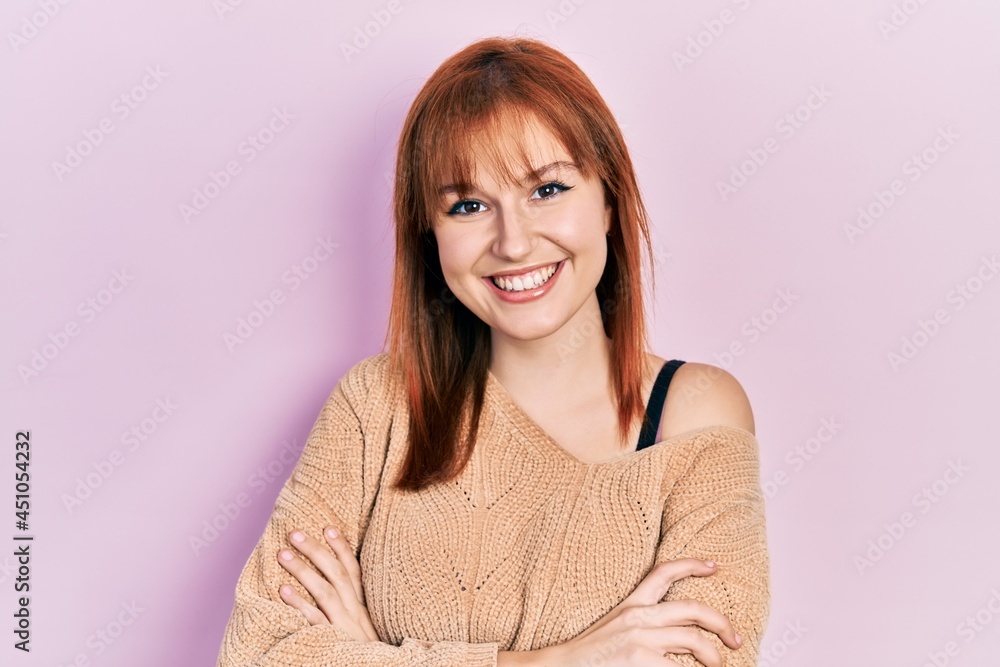 Redhead young woman wearing casual winter sweater happy face smiling with crossed arms looking at the camera. positive person. Redhead young woman wearing casual winter sweater happy face smiling with crossed arms looking at the camera. positive person.