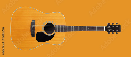 Musical instrument - Front view classic vintage acoustic guitar Isolated orange