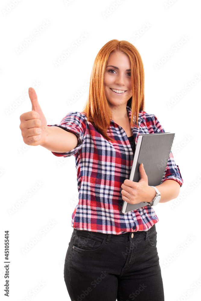 Smiling young woman holding a notebook and giving thumb up Smiling young woman holding a notebook and giving thumb up