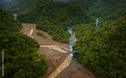 Confluence of the river Rio Sucio and Rio La Hondura in National Park Braulio Carillo, clear river and dirty river confluence, bridge over the river in Costa Rica, Central America photo