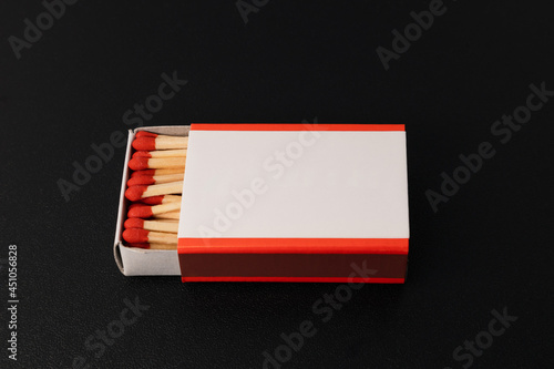 An open matchbox with a blank white label photo