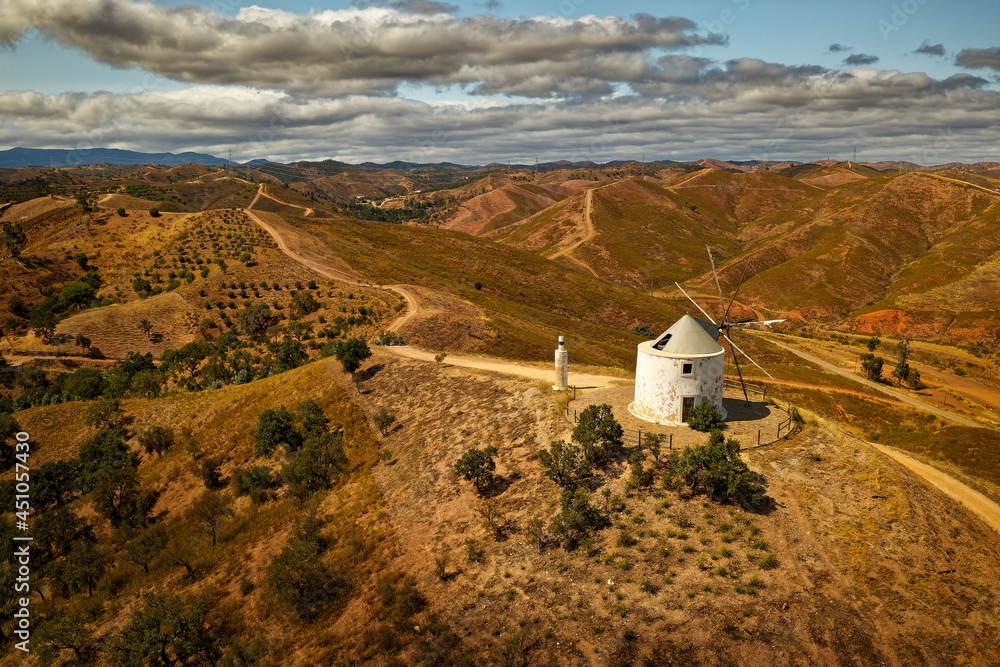 Old historical deserted windmill in Silves, Algarve, Portugal, aerial photo of the original traditional architecture in Iberian peninsula, mill on the hill