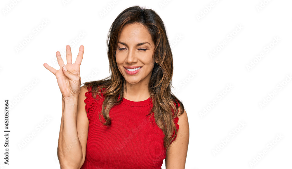 Young hispanic woman wearing casual clothes showing and pointing up with fingers number four while smiling confident and happy. Young hispanic woman wearing casual clothes showing and pointing up with fingers number four while smiling confident and happy.
