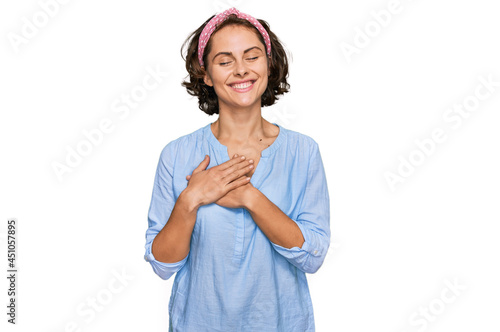 Young hispanic woman wearing casual clothes smiling with hands on chest with closed eyes and grateful gesture on face. health concept.