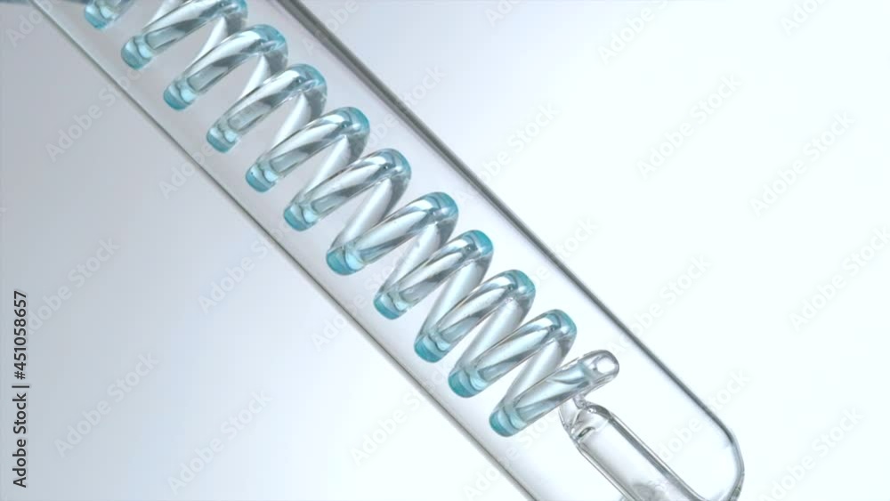 Glass big test tube with canister inside. Blue fluidity flows through spiral pipe. Laboratory experience and research. Production of cosmetics and perfumes. Liquid purification in the laboratory Glass big test tube with canister inside. Blue fluidity flows through spiral pipe. Laboratory experience and research. Production of cosmetics and perfumes. Liquid purification in the laboratory