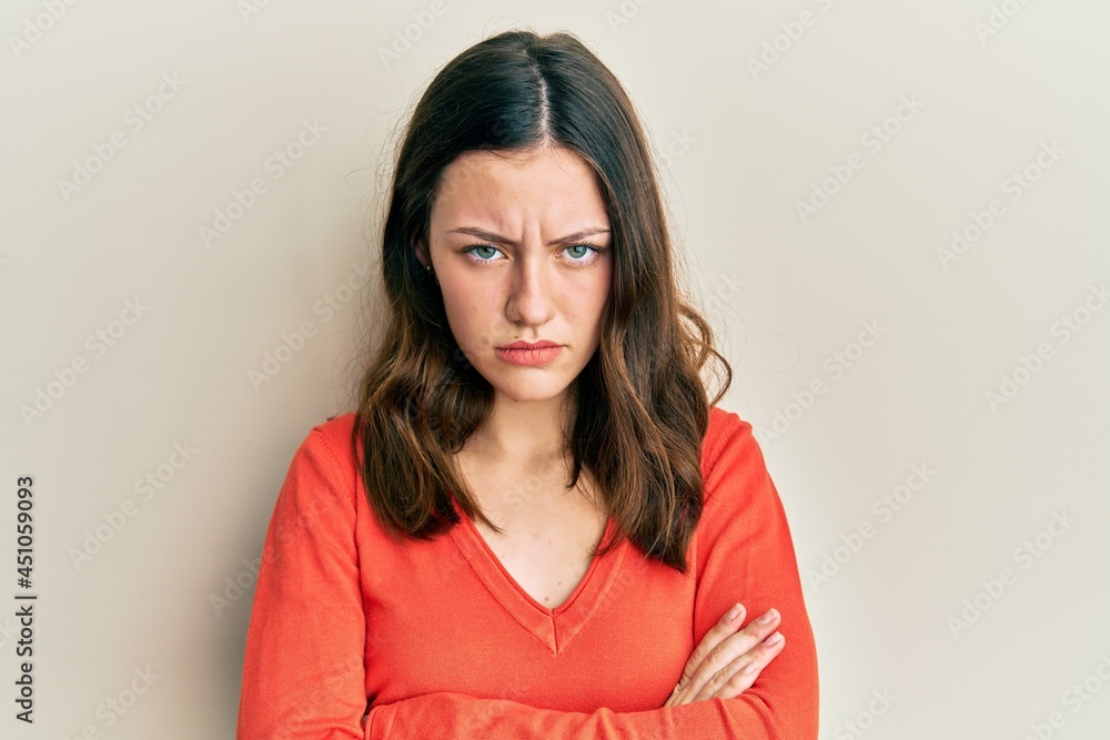 Obraz premium Young brunette woman wearing casual clothes skeptic and nervous, disapproving expression on face with crossed arms. negative person.