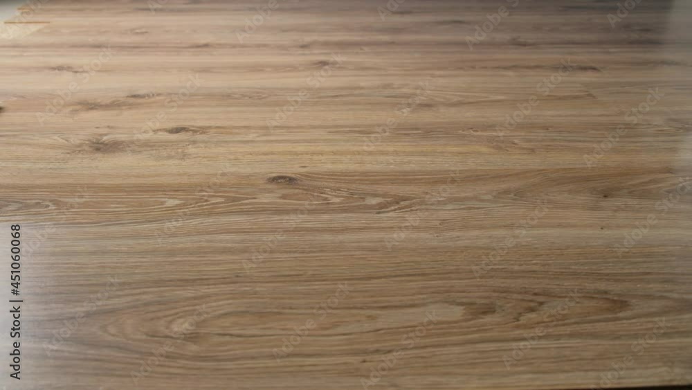 A spilled cup of coffee on the laminate floor is cleaned up with a mop close-up. A spilled cup of coffee on the laminate floor is cleaned up with a mop close-up.