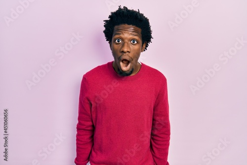 Young african american man wearing casual clothes afraid and shocked with surprise and amazed expression, fear and excited face.