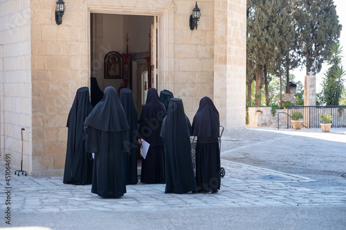 Nuns of Russian Orthodox Church going to morning prayer. Nuns in black robes.  © A.Pushkin