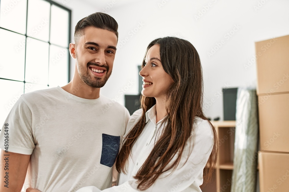 Young hispanic couple smiling happy and hugging at new home. Young hispanic couple smiling happy and hugging at new home.