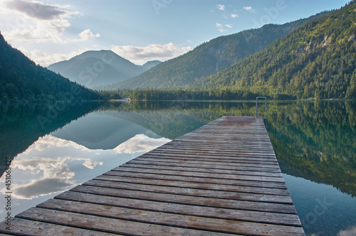 Dock leading into a beautiful mountain lake in the Austrian alps.