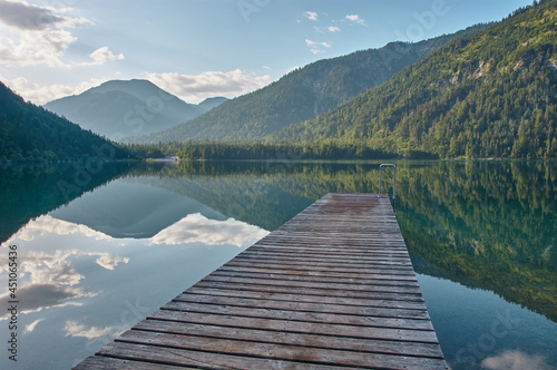 Dock leading into a beautiful mountain lake in the Austrian alps.