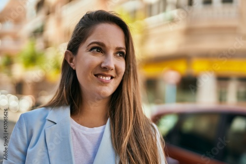 Wallpaper Mural Young blonde businesswoman smiling happy standing at the city. Torontodigital.ca
