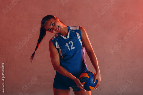 Young woman professional volleyball player with ball for volleyball.