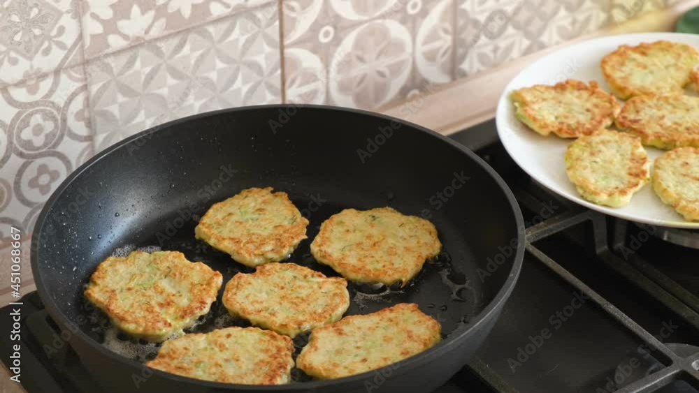 Cooking vegetable pancakes in a frying pan. Fry pancakes, fried golden crust pancakes. Cooking vegetarian food Cooking vegetable pancakes in a frying pan. Fry pancakes, fried golden crust pancakes. Cooking vegetarian food