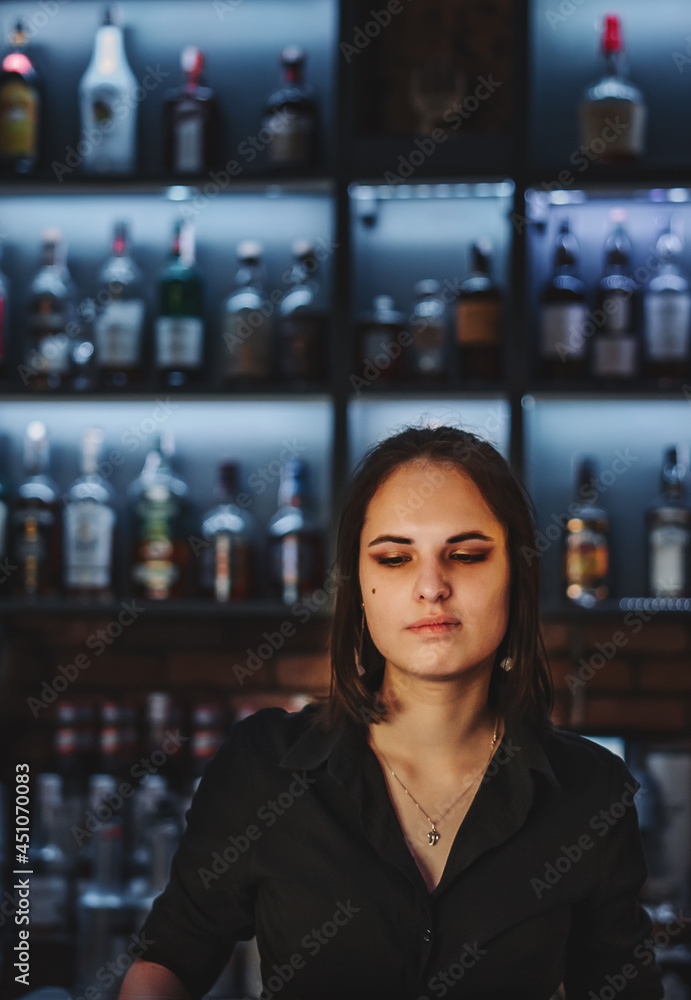 Portrait of young attractive woman bartender behind the bar counter Portrait of young attractive woman bartender behind the bar counter