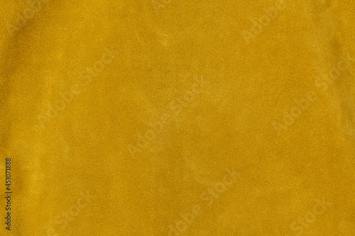 Saffron golden yellow textured suede leather surface background