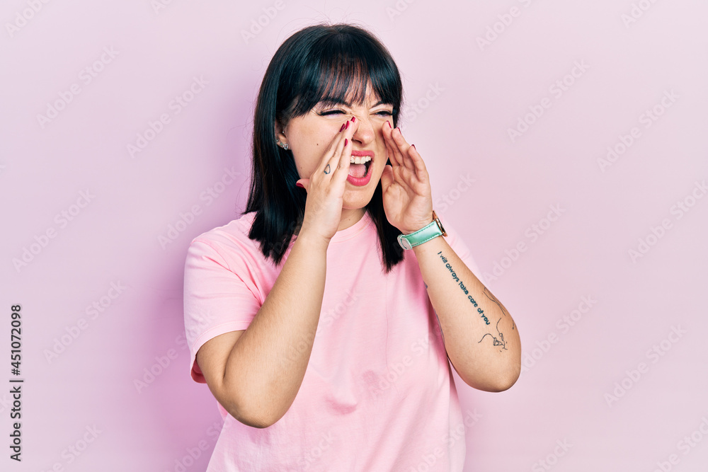 Young hispanic woman wearing casual clothes shouting angry out loud with hands over mouth Young hispanic woman wearing casual clothes shouting angry out loud with hands over mouth