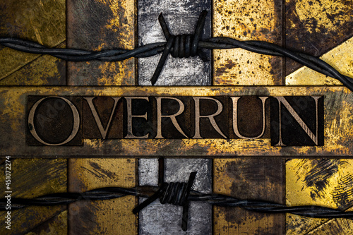 Overrun text message on textured grunge copper and vintage gold background with barbed wire