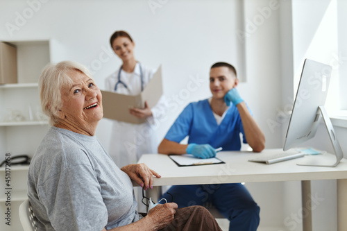 Cheerful elderly woman at the doctor s and nurse s appointment in the hospital