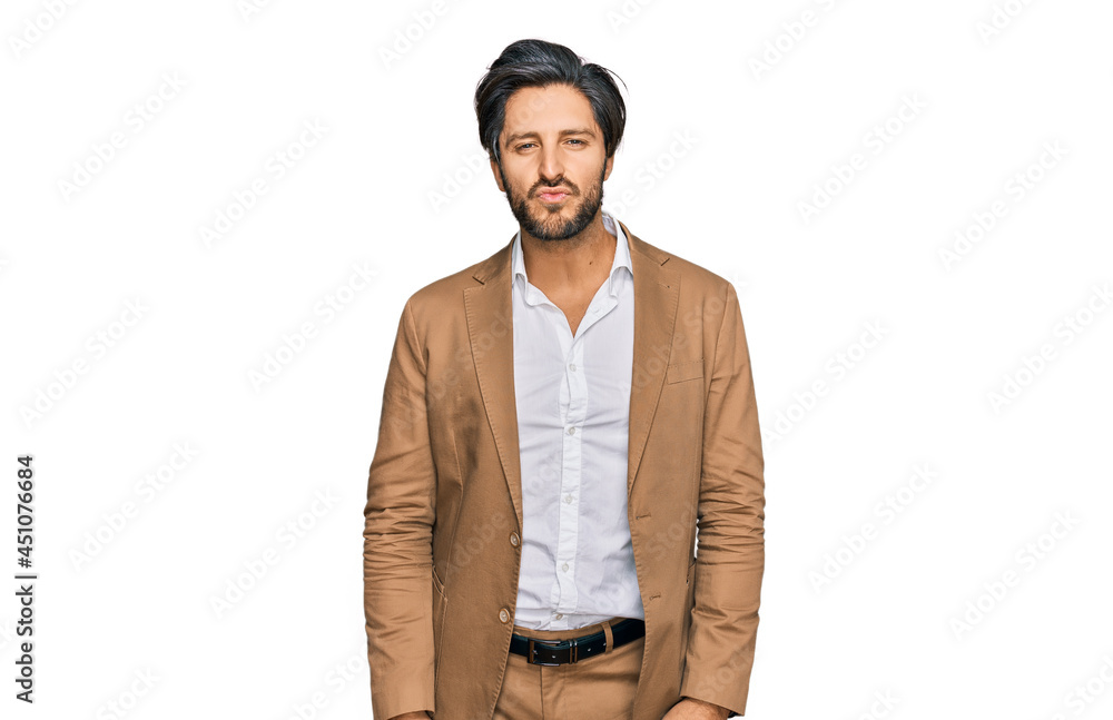 Young hispanic man wearing business clothes looking at the camera blowing a kiss on air being lovely and sexy. love expression. Young hispanic man wearing business clothes looking at the camera blowing a kiss on air being lovely and sexy. love expression.