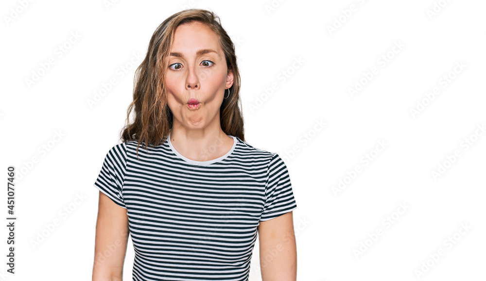 Young blonde woman wearing casual clothes making fish face with lips, crazy and comical gesture. funny expression. Young blonde woman wearing casual clothes making fish face with lips, crazy and comical gesture. funny expression.