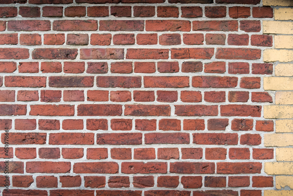Red brick wall with yellow border and without people Red brick wall with yellow border and without people