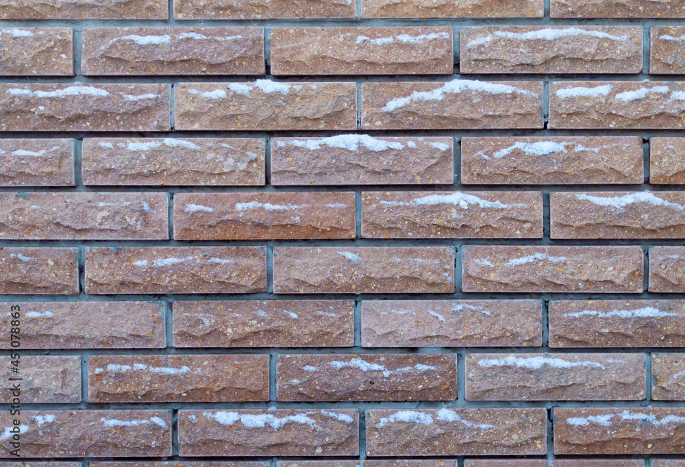 Obraz premium background brick fence in the snow