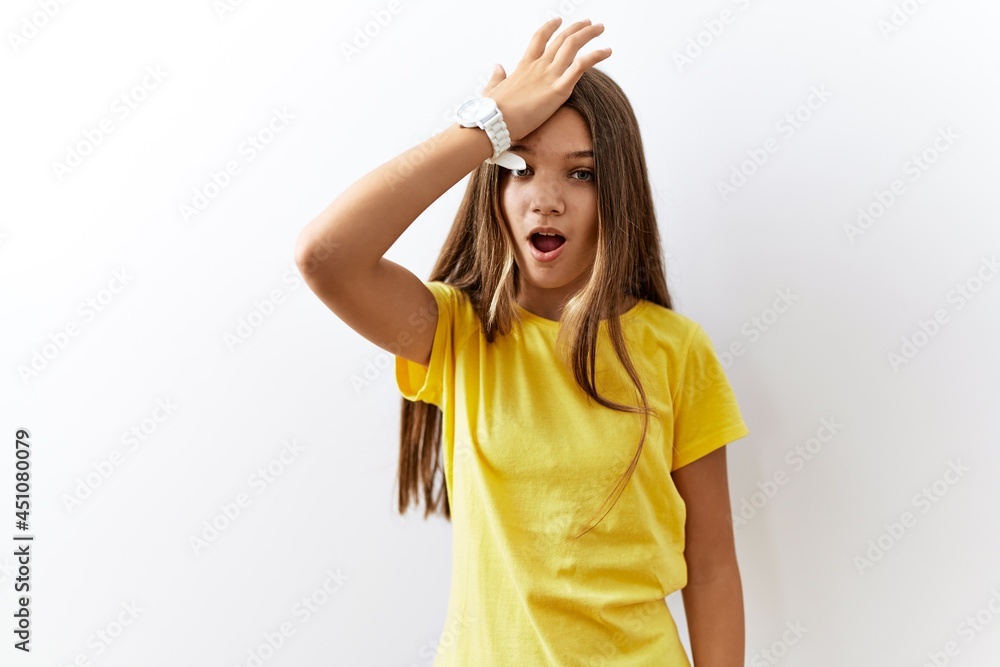 Young brunette teenager standing together over isolated background surprised with hand on head for mistake, remember error. forgot, bad memory concept. Young brunette teenager standing together over isolated background surprised with hand on head for mistake, remember error. forgot, bad memory concept.