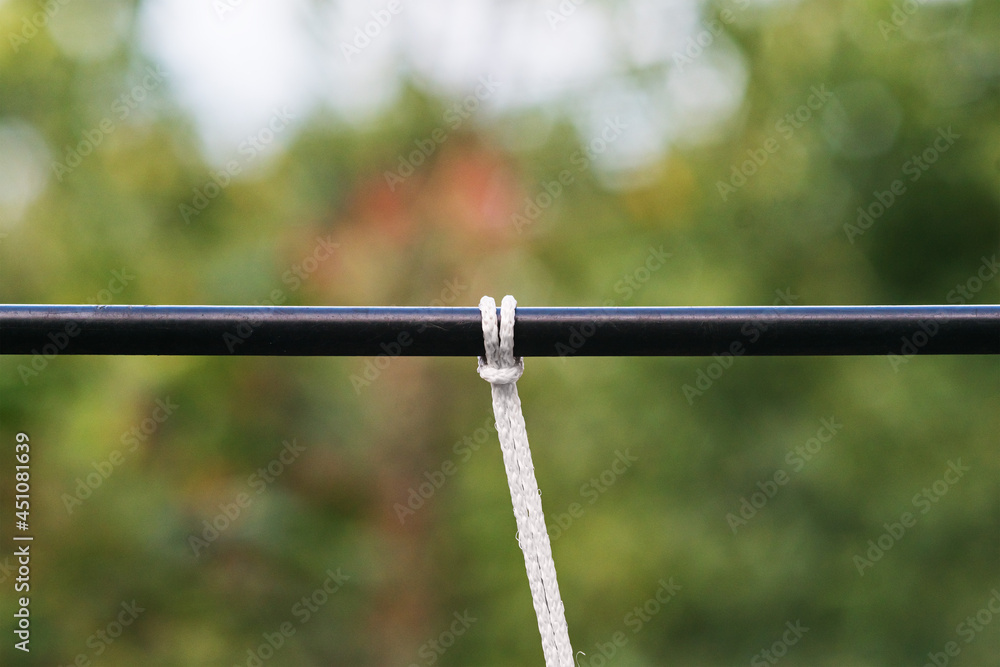 A white rope tied on a thick wire A white rope tied on a thick wire