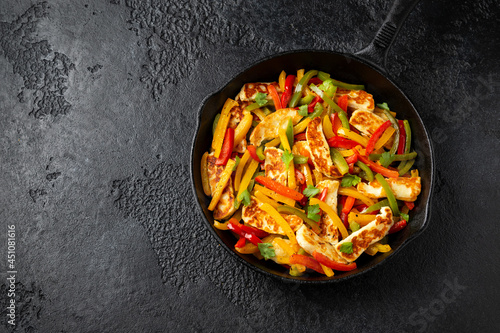 Tasty Halloumi cheese Fajitas with mix pepper in iron cast pan. Healthy food.