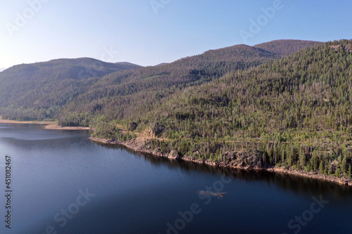 Aerial view of Lake Granby, Colorado and surrounding mountains and forests on clear calm summer morning.