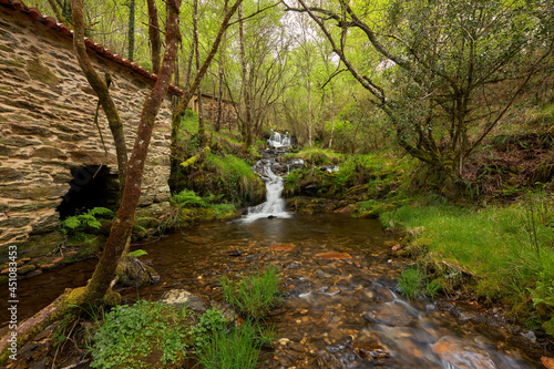 Small waterfall next to an old water mill in the area of Galicia, Spain. photo