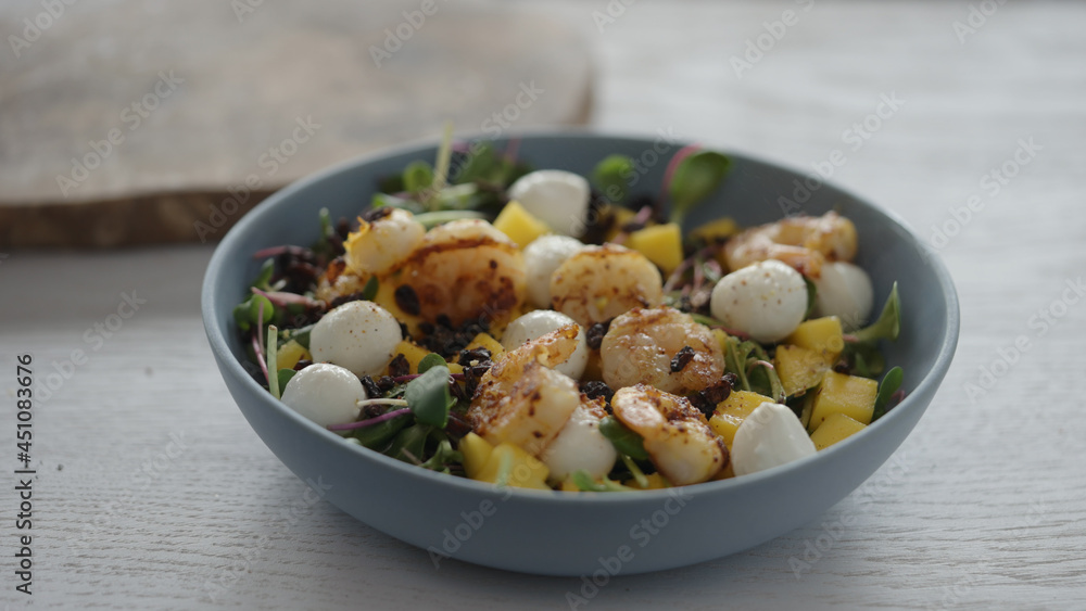 seasoning salad with shrimps, mango, mozzarella and micro greens seasoning salad with shrimps, mango, mozzarella and micro greens