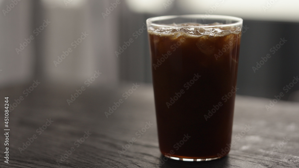 Making espresso tonic in tumbler glass, pour tonic