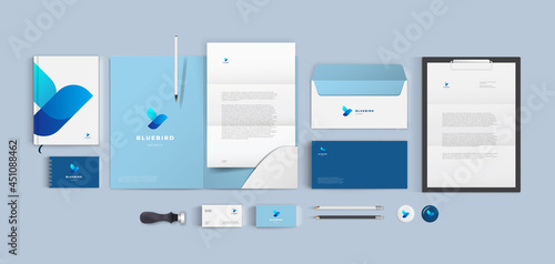 Top view stationery design mock up set for corporate identity or branding on table. Blue color style and grey background. Realistic bundle with folder, letter, envelope and business card. photo