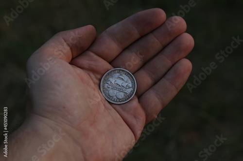 Vintage American coin half dollar in hand