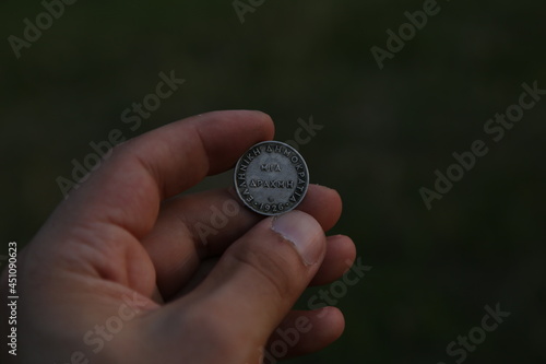 Old coin from Greece in hand