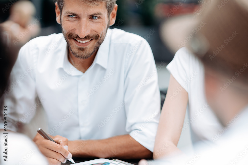 Obraz premium smiling businessman sitting at an office desk.
