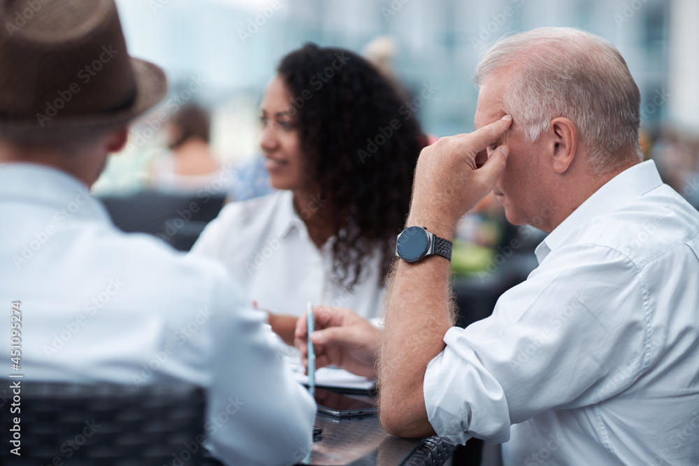 mature businessman is considering a new offer from his business partners . close-up. mature businessman is considering a new offer from his business partners . close-up.