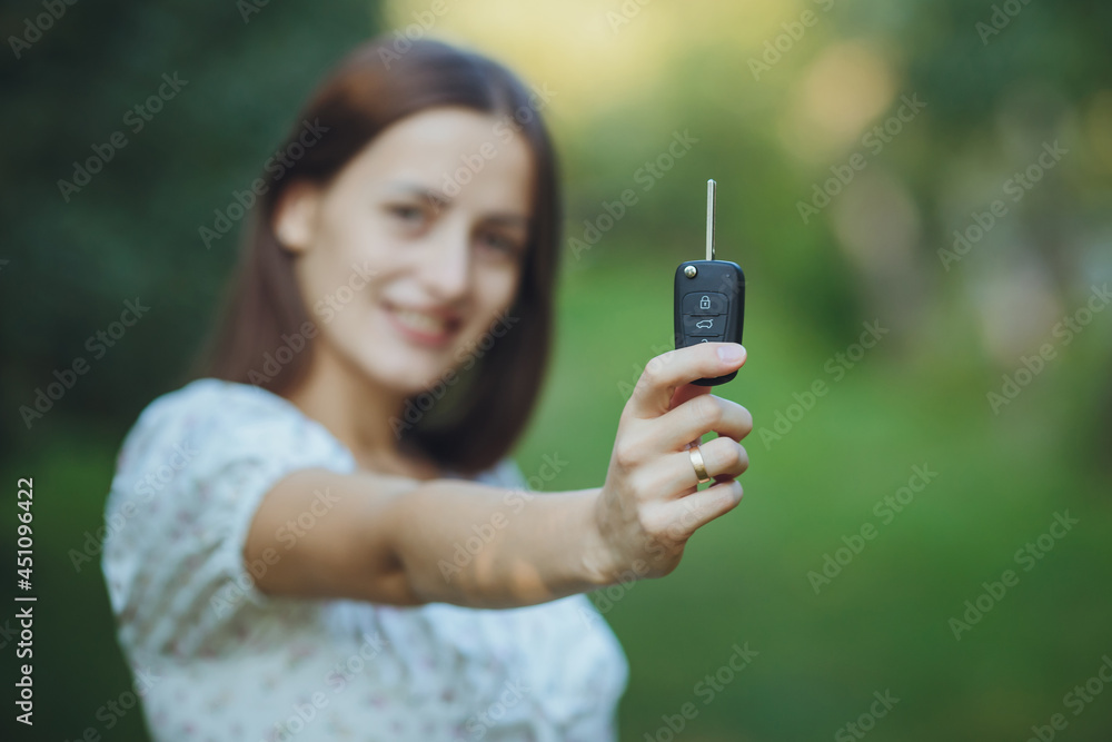 Young beautiful girl holding car keys in hand