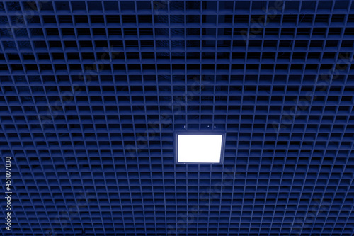 Mesh suspended ceiling with fluorescent or LED square lights in a modern shopping center or office building