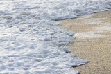 white sea foam near the shore close-up, waves