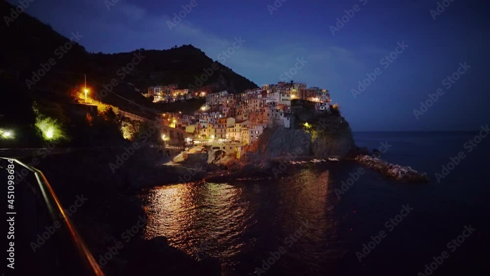 Manarola in Italy, beautiful town at night. Famous and popular tourist destination during sundown. Illuminated Town at the Mediterranean Sea Manarola in Italy, beautiful town at night. Famous and popular tourist destination during sundown. Illuminated Town at the Mediterranean Sea